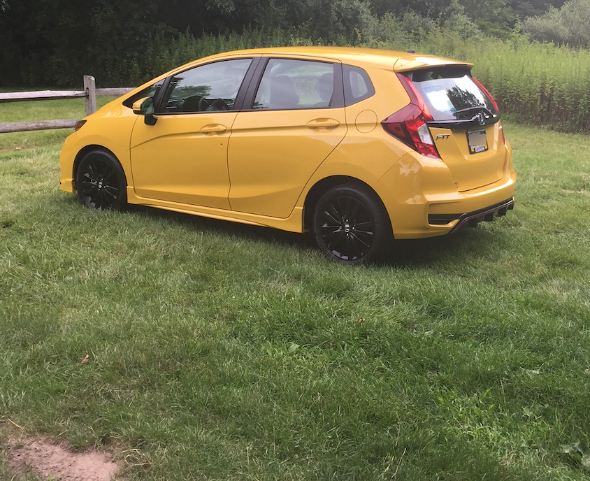 A car parked in a grassy field Description automatically generated